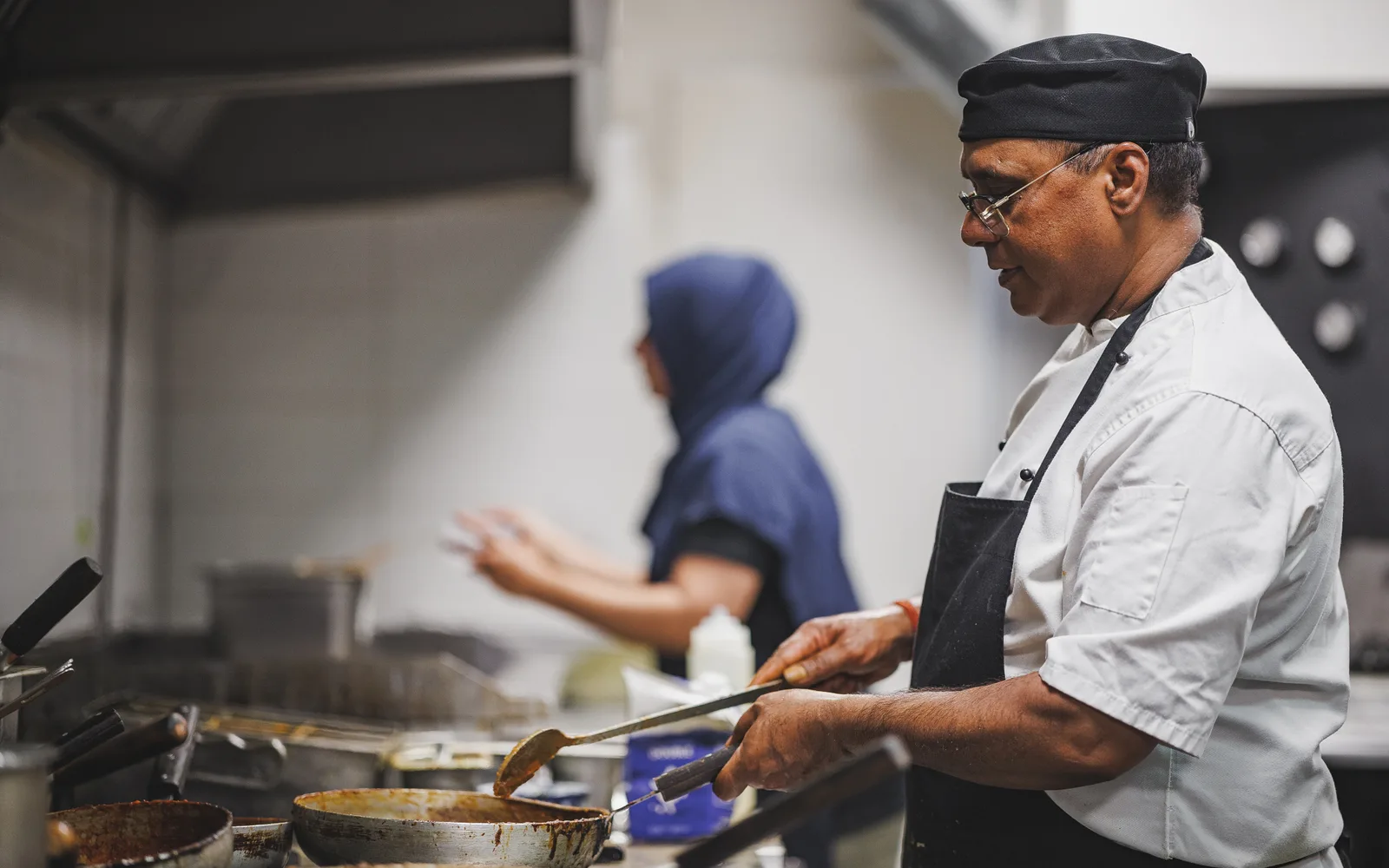 A Padharo chef cooking a fresh order in the restaurant kitchen, ready for delivery across Southampton