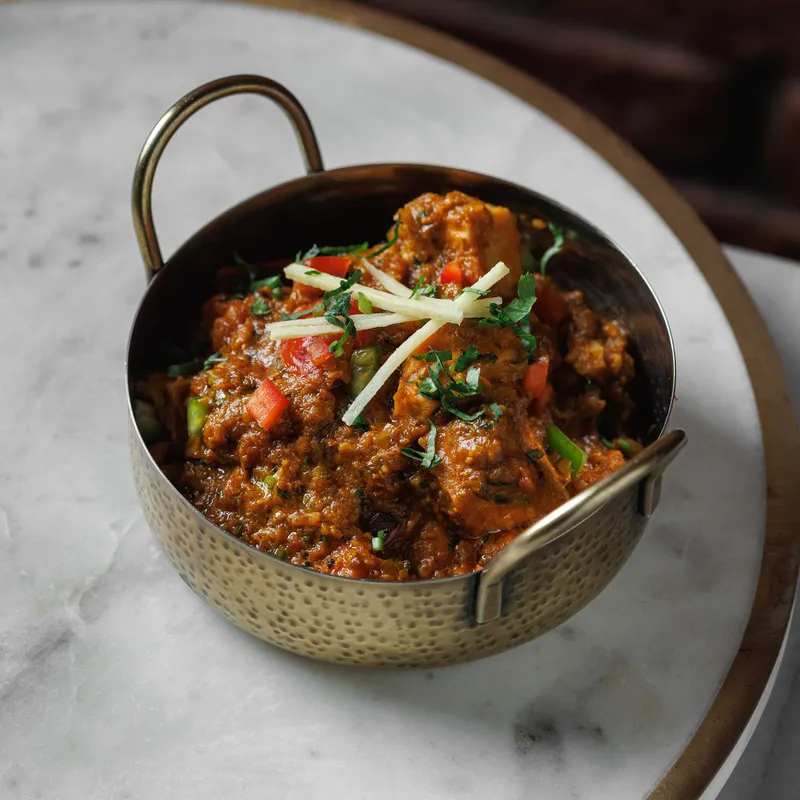 Jackfruit Rogan Josh - Young jackfruit slow-simmered in a rich Kashmiri-style sauce, finished with charcoal smoke, vegetarian Indian dish at Padharo Southampton